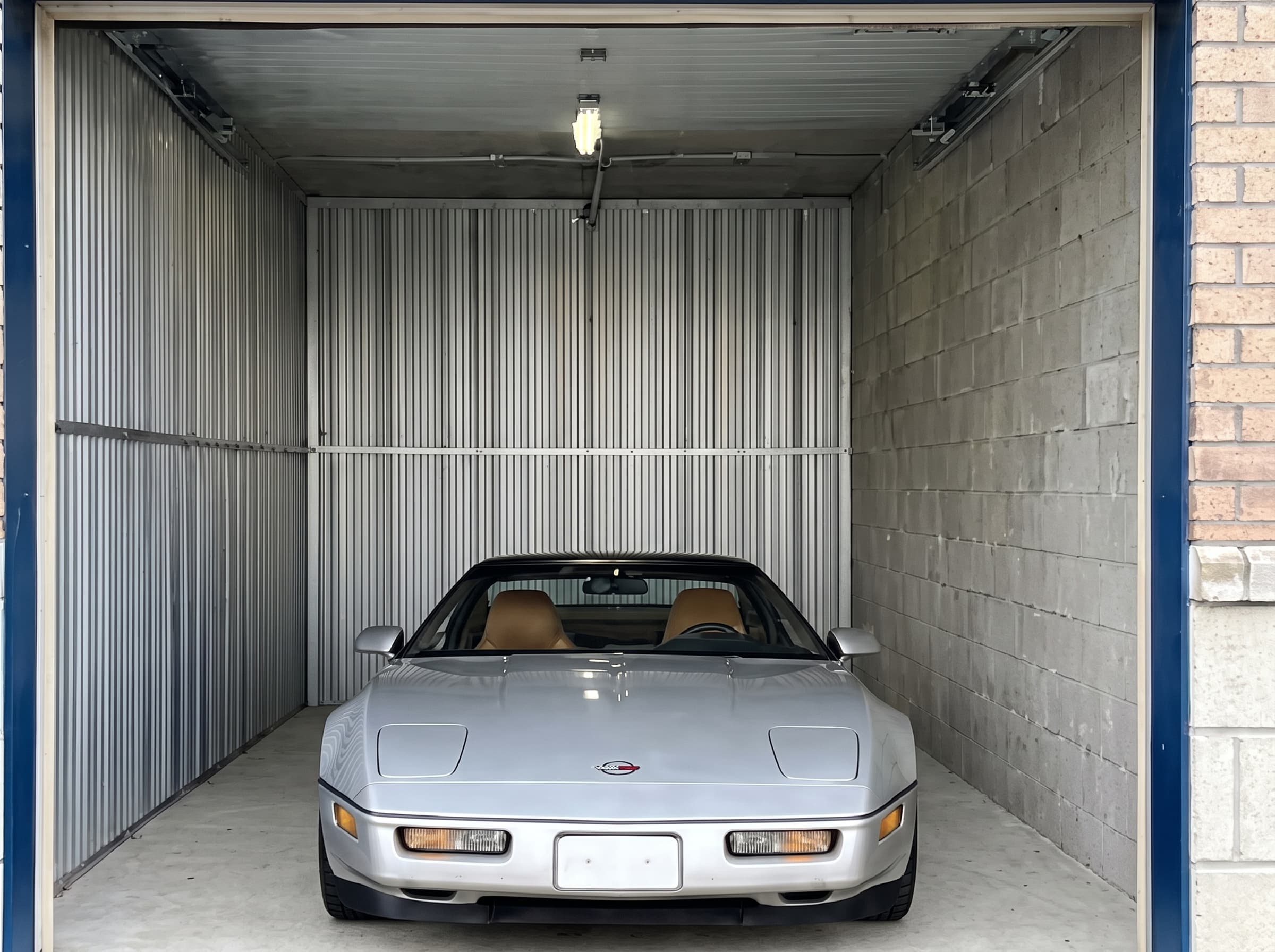 Private enclosed vehicle bay with a roll-up door for indoor car storage in Bridgehampton, NY